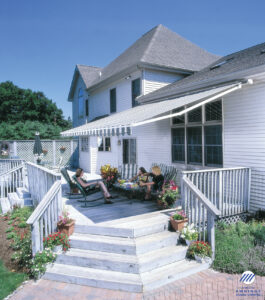 House patio with awning and people relaxing.