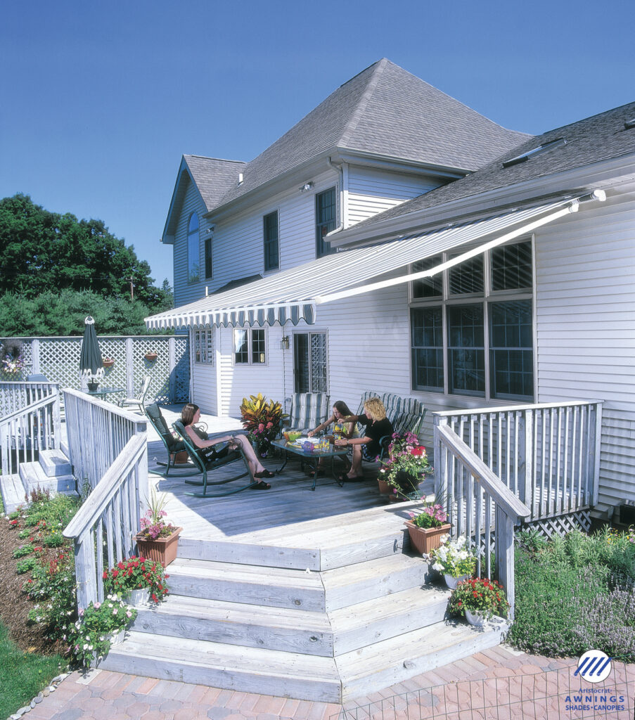 House patio with awning and people relaxing.