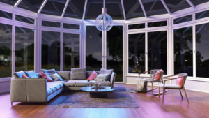 Modern living room with glass walls at night.